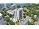 Scenic aerial view of a high-rise condominium surrounded by lush greenery and overlooking a tranquil lake at 530 E Central Blvd # 1901, Orlando, FL 32801