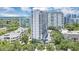 Impressive aerial view of a high-rise condo, with a pool, surrounded by lush trees and cityscape at 530 E Central Blvd # 1901, Orlando, FL 32801