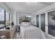 Bright bedroom featuring a tufted headboard, large windows, and sleek, mirrored bedside tables at 530 E Central Blvd # 1901, Orlando, FL 32801