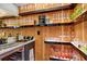 Stylish wet bar with wood paneled walls, marble countertop, wine cooler, and glass shelving at 530 E Central Blvd # 1901, Orlando, FL 32801