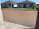 A view of a home's backyard with an unfinished ground cover, complemented by the home's exterior and landscaping at 5738 Cattle Ranch Dr, St Cloud, FL 34771