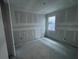 Bedroom with a window, concrete floors, and white walls at 5738 Cattle Ranch Dr, St Cloud, FL 34771