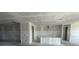 Spacious unfinished kitchen area with freshly-installed drywall and bare concrete floors, ready for customization at 5738 Cattle Ranch Dr, St Cloud, FL 34771