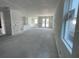 Spacious living room with smooth concrete floors and light-filled windows at 5738 Cattle Ranch Dr, St Cloud, FL 34771