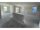 A spacious unfinished living space with drywall, recessed lighting and large windows, ready for customization at 5738 Cattle Ranch Dr, St Cloud, FL 34771