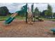 Community playground area with a climbing structure and slide on a bed of mulch at 5738 Cattle Ranch Dr, St Cloud, FL 34771