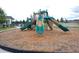 Community playground with slides and play equipment on a mulch surface, surrounded by green spaces at 5738 Cattle Ranch Dr, St Cloud, FL 34771