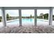 Scenic view of the community pool area featuring a covered patio with stone flooring at 5738 Cattle Ranch Dr, St Cloud, FL 34771