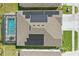 Aerial view of home's roof highlighting solar panels and screened-in pool, demonstrating energy efficiency and outdoor amenities at 588 Hitch Loop, St Cloud, FL 34772