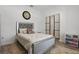 Comfortable bedroom featuring a stylish bed frame, wood floors, decorative rug and closet with black trim at 588 Hitch Loop, St Cloud, FL 34772