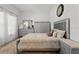 Cozy bedroom with a queen-sized bed, gray headboard, dresser, and warm-toned rug at 588 Hitch Loop, St Cloud, FL 34772