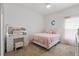 Charming bedroom with a pink-themed decor, a vanity with lights, and soft natural light at 588 Hitch Loop, St Cloud, FL 34772