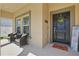 Inviting front porch with seating, a wreath, and a welcome mat, creating a warm and welcoming entrance at 588 Hitch Loop, St Cloud, FL 34772