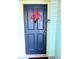 Charming blue front door with decorative 'Hugs & Kisses' decor and visible house number at 611 Campus St # 320, Kissimmee, FL 34747