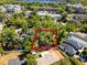 Aerial view of a property surrounded by lush trees, offering privacy and seclusion from the neighborhood at 651 Robinhood Dr, Maitland, FL 32751