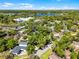 Aerial view of a residential area, with blue lakes in the distance, surrounded by lush green trees and homes at 651 Robinhood Dr, Maitland, FL 32751