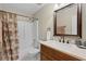 Well-lit bathroom showcases a classic vanity, tiled shower, and coordinated accessories for a refined aesthetic at 651 Robinhood Dr, Maitland, FL 32751