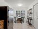 Bright breakfast nook includes a window for light and adjacent stainless steel refrigerator at 651 Robinhood Dr, Maitland, FL 32751