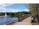 Scenic view of a serene lake with a fountain, complemented by a charming wooden bridge at 651 Robinhood Dr, Maitland, FL 32751