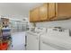 Spacious laundry room featuring modern appliances, ample cabinet space, and organized storage solutions at 651 Robinhood Dr, Maitland, FL 32751