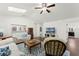 Bright living room features hardwood floors, a ceiling fan, and multiple skylights at 651 Robinhood Dr, Maitland, FL 32751