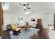 Bright living room features hardwood floors, a ceiling fan, and multiple skylights at 651 Robinhood Dr, Maitland, FL 32751