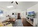 Bright living room features hardwood floors, a ceiling fan, and multiple skylights at 651 Robinhood Dr, Maitland, FL 32751