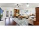 Bright living room featuring hardwood floors, vaulted ceilings, and a door to the back yard at 651 Robinhood Dr, Maitland, FL 32751