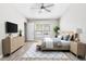 Cozy bedroom with modern furniture, light gray walls, and an abundance of natural light at 6847 Sperone St, Orlando, FL 32819