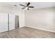 Bedroom with closet, ceiling fan and wood-look flooring at 6847 Sperone St, Orlando, FL 32819