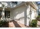 Close-up of exterior walls, front door and walkway featuring white trim and brick flooring at 6847 Sperone St, Orlando, FL 32819