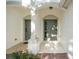 Covered entranceway featuring a concrete floor, olive green doors, and shared support column at 6847 Sperone St, Orlando, FL 32819