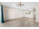 Open living room with modern ceiling fan, adjacent to a stylish kitchen at 6847 Sperone St, Orlando, FL 32819