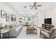 Cozy living room with modern furnishings and a view of the dining area at 6847 Sperone St, Orlando, FL 32819