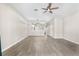 Open living room with modern ceiling fan, adjacent to a stylish kitchen at 6847 Sperone St, Orlando, FL 32819