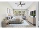 Staged main bedroom suite featuring natural light, ceiling fan and en-suite bathroom at 6847 Sperone St, Orlando, FL 32819