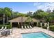 Community pool and lounge area featuring a splash pool, seating and mature landscaping at 6847 Sperone St, Orlando, FL 32819