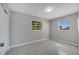 Well-lit bedroom featuring a window and tiled flooring, offering a clean and modern feel at 73 Garrison Ln, Frostproof, FL 33843