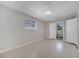 Well-lit bedroom with tile flooring, a window, and a closet door leading to the utility room at 73 Garrison Ln, Frostproof, FL 33843