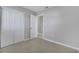 Bright bedroom featuring tile flooring, baseboard trim, and a double door closet at 73 Garrison Ln, Frostproof, FL 33843