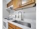 Close-up of stainless steel sink, modern faucet, and white countertops in the kitchen at 73 Garrison Ln, Frostproof, FL 33843