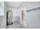 Utility room featuring a water heater, shelving, and access to other areas of the home at 73 Garrison Ln, Frostproof, FL 33843