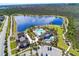Aerial view of a stunning community amenities center including a pool, splashpad, and clubhouse on a pond at 8433 Corkfield Ave, Orlando, FL 32832