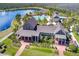 Aerial view of the community clubhouse, pool, lake, and surrounding landscaping at 8433 Corkfield Ave, Orlando, FL 32832