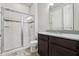 Modern bathroom featuring a glass-enclosed shower and a stylish vanity with granite countertop at 8433 Corkfield Ave, Orlando, FL 32832