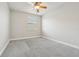 This bedroom features neutral walls, carpet floors, a ceiling fan, and a window at 8433 Corkfield Ave, Orlando, FL 32832