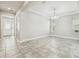 Dining room featuring tile floors, modern chandelier, neutral paint, tray ceiling, and natural light at 8433 Corkfield Ave, Orlando, FL 32832