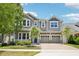 Charming two-story home featuring a brick driveway, two-car garage, and beautifully landscaped front yard at 8433 Corkfield Ave, Orlando, FL 32832