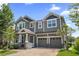 Beautiful two-story home featuring a brick driveway, attached two-car garage, and a covered front porch at 8433 Corkfield Ave, Orlando, FL 32832