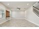 An empty living room with tile floors, a ceiling fan, and a staircase at 8433 Corkfield Ave, Orlando, FL 32832
